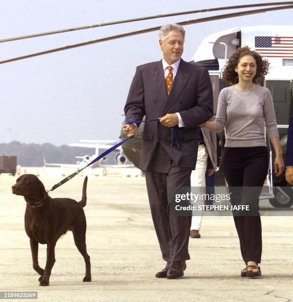 President Bill Clinton leads his dog, Buddy, and his daughter Chelsea towards Air Force One 18 August at Andrews Air Force Base, MD, on their way to...