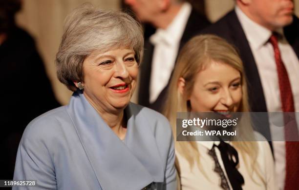 Former Prime Minister Theresa May walks with other Members of Parliament through the Commons Members Lobby to hear the state opening of parliament at...