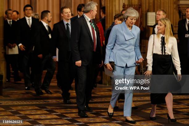 Former Prime Minister Theresa May walks with other Members of Parliament through the Commons Members Lobby to hear the state opening of parliament at...