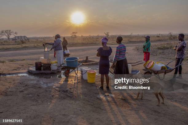 Bloomberg Pictures Of The Year 2019: Threatened Planet. Local residents queue to fill buckets and containers with water at a communal tap in...