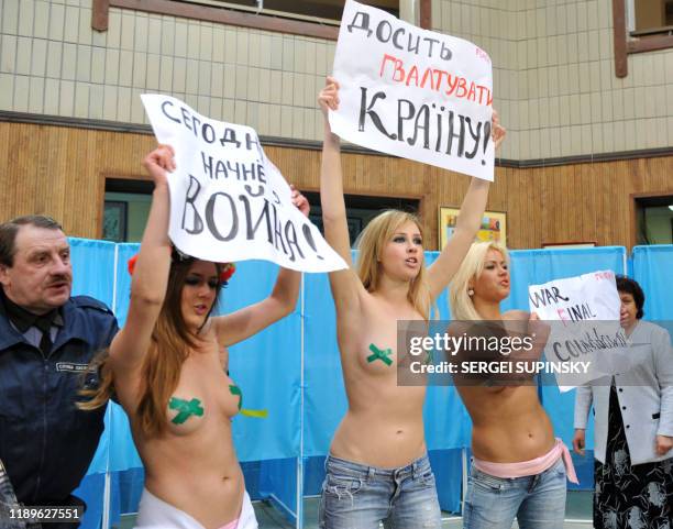 Activists of the Ukrainian women's movement FEMEN stage a protest prior to the Ukrainian opposition leader, presidential candidate Viktor Yanukovich...