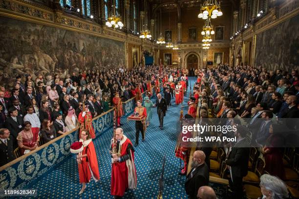 Queen Elizabeth II and Prince Charles, Prince of Wales proceed through the Royal Gallery on their way to the Lord's Chamber to attend the State...