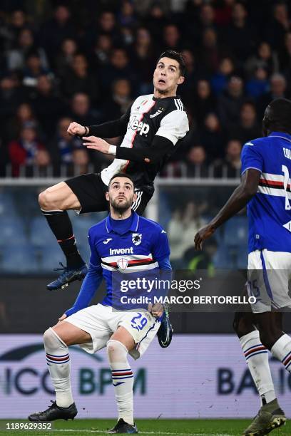 Juventus' Portuguese forward Cristiano Ronaldo jumps to score a header during the Italian Serie A football match Sampdoria vs Juventus on December...