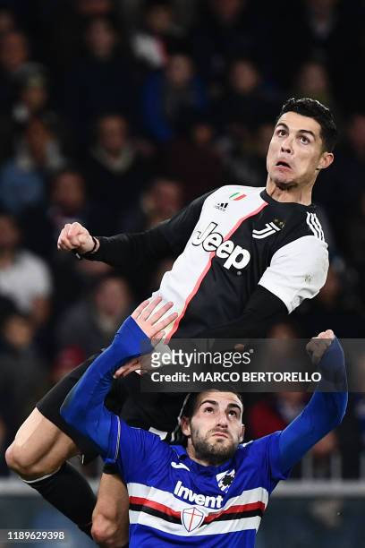 Juventus' Portuguese forward Cristiano Ronaldo jumps above Sampdoria's Italian defender Nicola Murru to score a header during the Italian Serie A...