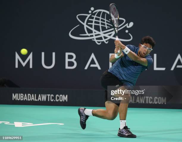 South Korea's Chung Hyeon returns the ball to Russia's Karen Khachanov during the Mubadala World Tennis Championship at Zayed Sports City in Abu...