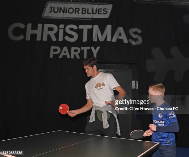 Marcos Alonso of Chelsea plays Table Tennis with a Junior blue during the Junior Blues Christmas Party at Stamford Bridge on December 19, 2019 in...