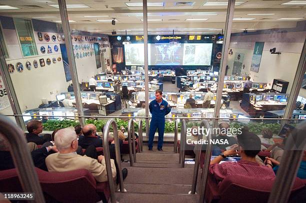In this handout image provided by the National Aeronautics and Space Administration , NASA astronaut Stan Love briefs visitors in the viewing room at...