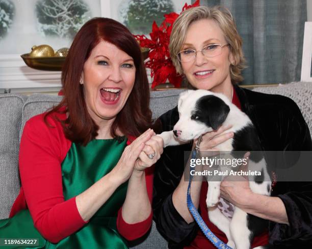 Actors Kate Flannery and Jane Lynch poses with a rescue dog on the set of Hallmark Channel's "Home & Family" at Universal Studios Hollywood on...