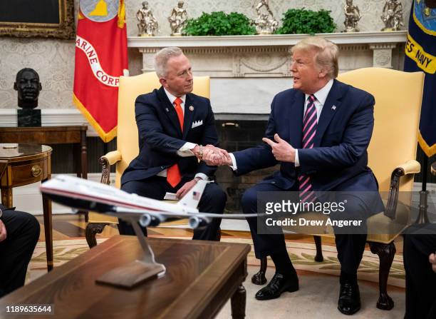 Rep. Jeff Van Drew of New Jersey, who has announced he is switching from the Democratic to Republican Party, shakes hands with U.S. President Donald...