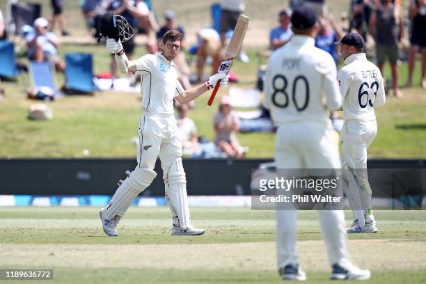 Mitchell Santner of New Zealand celebrates his century during day four of the first Test match between New Zealand and England at Bay Oval on...
