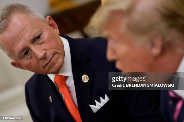 Rep. Jeff Van Drew , who is switching from the Democratic Party to the Republican Party, listens to US President Donald Trump during a meeting in the...