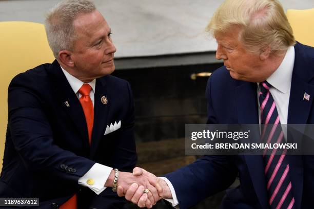 Rep. Jeff Van Drew , who is switching from the Democratic Party to the Republican Party, shakes hands with US President Donald Trump during a meeting...