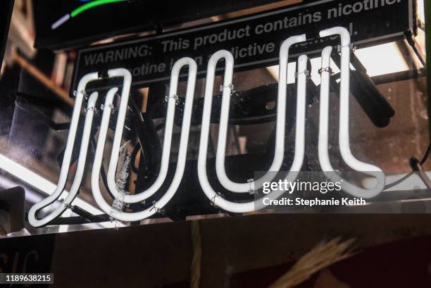 Sign advertising JUUL products is displayed in a store on December 19, 2019 in New York City. Congress raised the legal age to smoke or vape to 21....