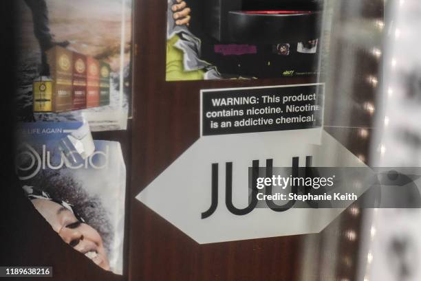 Sign advertising JUUL products is displayed in a store on December 19, 2019 in New York City. Congress raised the legal age to smoke or vape to 21....