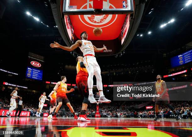 De'Andre Hunter of the Atlanta Hawks dunks during the second half of an NBA game against the Utah Jazz at State Farm Arena on December 19, 2019 in...