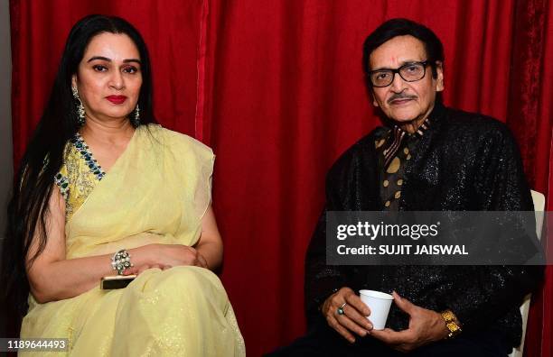 In this picture taken on December 19, 2019 Bollywood actress Padmini Kolhapure sits with Bollywood actor Biswajit Chatterjee at an event to celebrate...