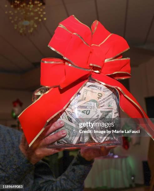 man holding up big jar of money - christmas cash stock pictures, royalty-free photos & images