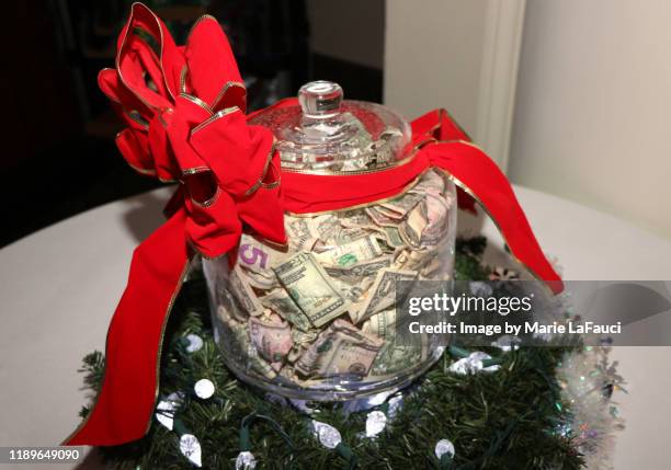 big jar of money with red bow - gratitude jar stock pictures, royalty-free photos & images