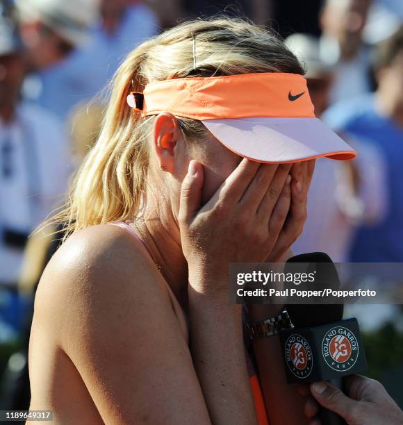 Maria Sharapova of Russia reacts in the media interview following her victory in her women's singles final match against Simona Halep of Romania on...