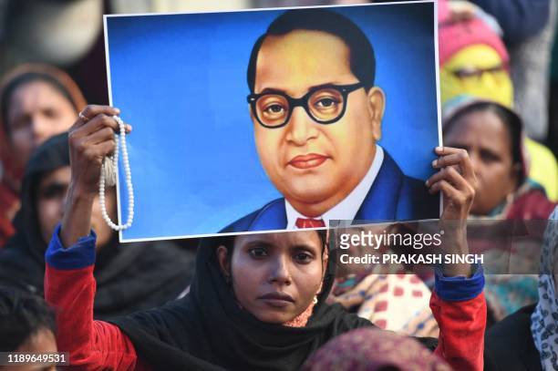 Protesters holds a placard of 20th century Indian political leader B. R. Ambedkar at a demonstration against India's new citizenship law in New Delhi...