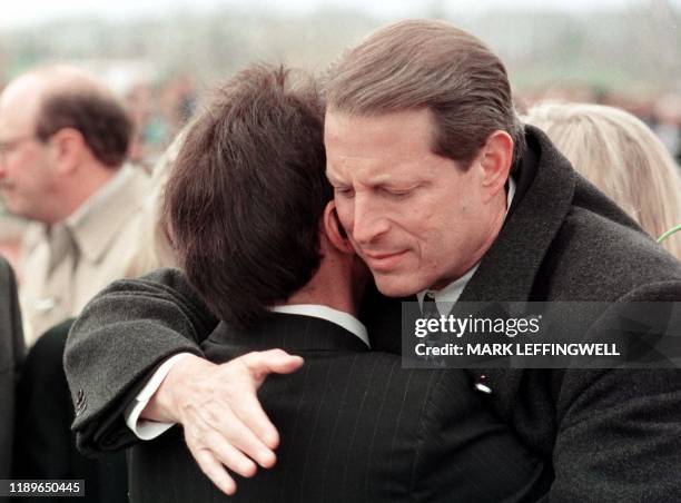 Vice President Al Gore hugs Columbine High School Principal Frank DeAngelis after laying flowers at the base of a wreath in Clement Park 25 April...