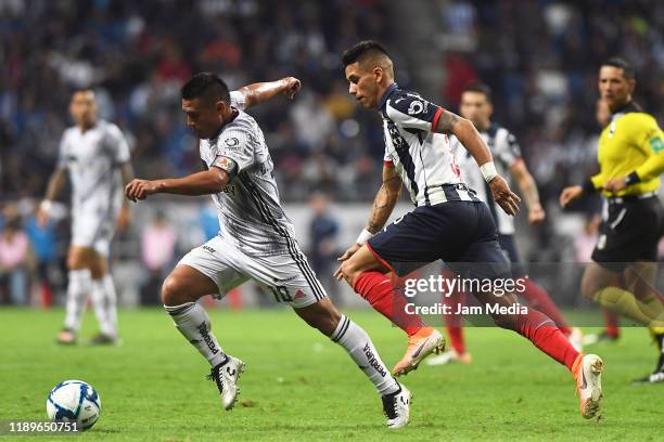 Osvaldo Martinez of Atlas fights for the ball with Maximiliano Meza of Monterrey during the 19th round match between Monterrey and Atlas as part of...