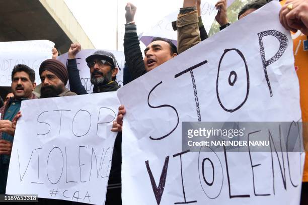Sikh and Hindu refugees from Pakistan and Afghanistan hold placards during a peaceful march in favour of India's new citizenship law in Amritsar on...