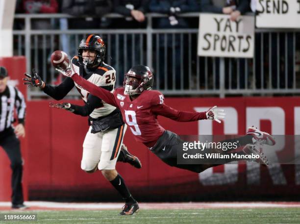 Renard Bell of the Washington State Cougars attempts to catch a pass against David Morris of the Oregon State Beavers in the first half at Martin...