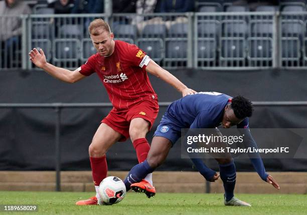 Herbie Kane of Liverpool and Arnaud Kalimuendo of Paris Saint Germain in action during the Premier League International Cup game at the Kirkby...