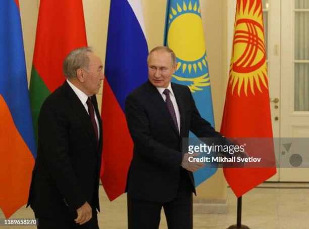 Russian President Vladimir Putin greets First Kazakh President Nursultan Nazarbayev during the welcoming ceremonyon December 20, 2019 in Saint...