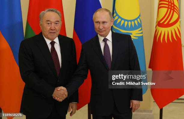 Russian President Vladimir Putin greets First Kazakh President Nursultan Nazarbayev during the welcoming ceremonyon December 20, 2019 in Saint...