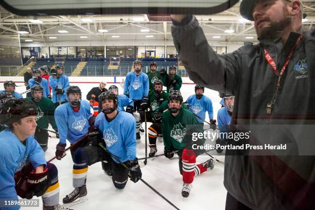 Head coach Greg Leclair runs through a practice drill with his team at the Windham/Westbrook/Bonny Eagle boys hockey practice early Tuesday, Dec. 10,...