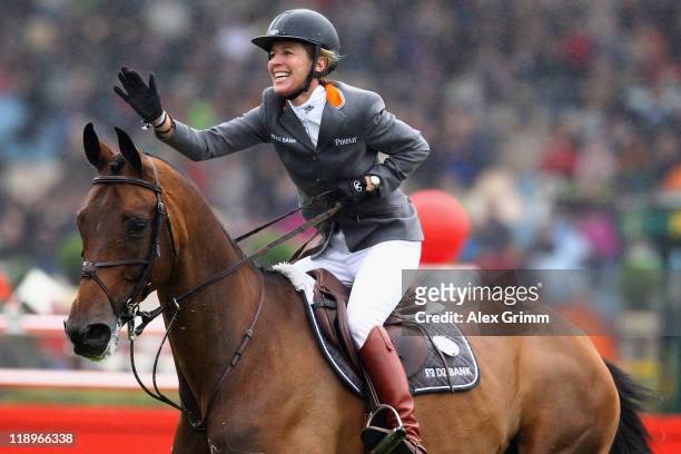 Meredith Michaels-Beerbaum of Germany on her horse Shutterfly celebrates after winning the Warsteiner jumping competition at the CHIO on July 13,...