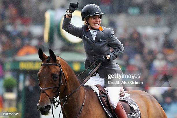 Meredith Michaels-Beerbaum of Germany on her horse Shutterfly celebrates after winning the Warsteiner jumping competition at the CHIO on July 13,...