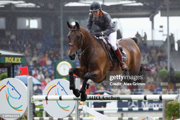 Meredith Michaels-Beerbaum of Germany clears a jump on her horse Shutterfly during the Warsteiner jumping competition at the CHIO on July 13, 2011 in...