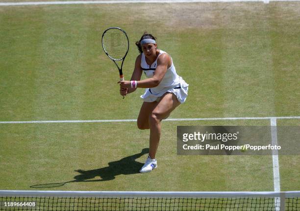 Marion Bartoli of France returns a backhand during the Women's Singles Final against Sabine Lisicki of Germany on day twelve of the Wimbledon Lawn...