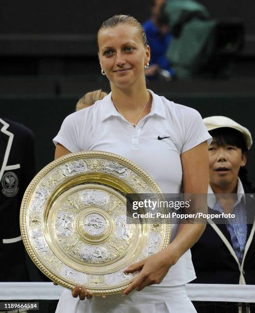 Petra Kvitova of the Czech Republic poses with the Venus Rosewater Dish as she celebrates winning the women's singles final match against Eugenie...