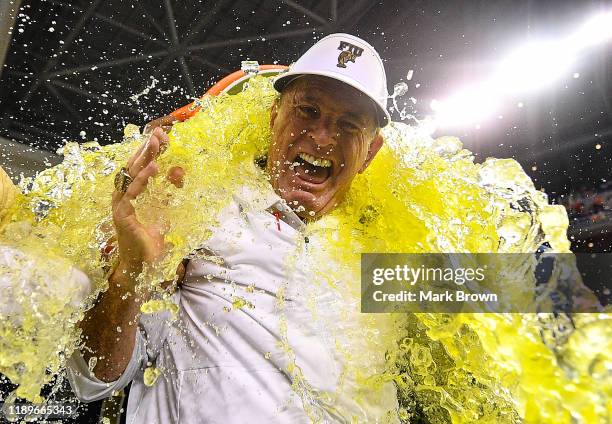 Head coach Butch Davis of the FIU Golden Panthers gets a Gatorade shower after the victory over the Miami Hurricanes at Marlins Park on November 23,...