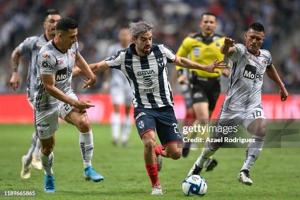 Rodolfo Pizarro, #20 of Monterrey, fights for the ball with Faberth Balda, #20, and Osvaldo Martínez, #10 of Atlas, during the 19th round match...