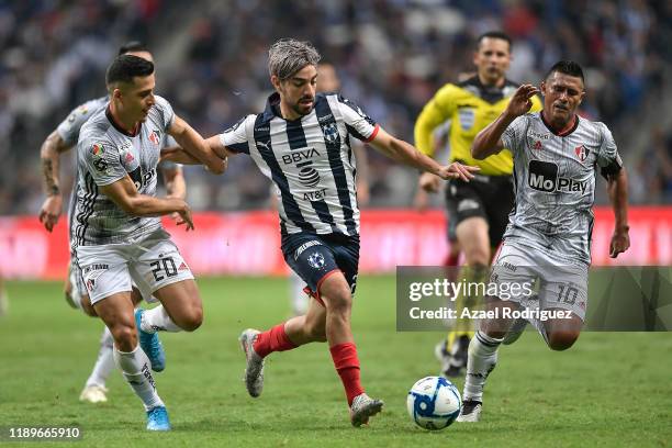Rodolfo Pizarro, #20 of Monterrey, fights for the ball with Faberth Balda, #20, and Osvaldo Martínez, #10 of Atlas, during the 19th round match...