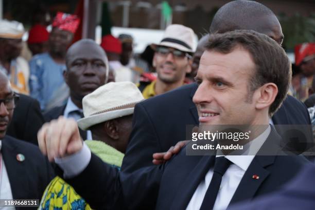 French President Emmanuel Macron and his wife Brigitte Macron are being welcomed by President of Ivory Coast Alassane Ouattara and his wife Dominique...