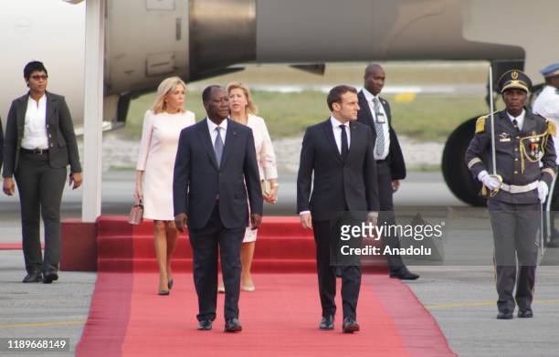 French President Emmanuel Macron and his wife Brigitte Macron are being welcomed by President of Ivory Coast Alassane Ouattara and his wife Dominique...