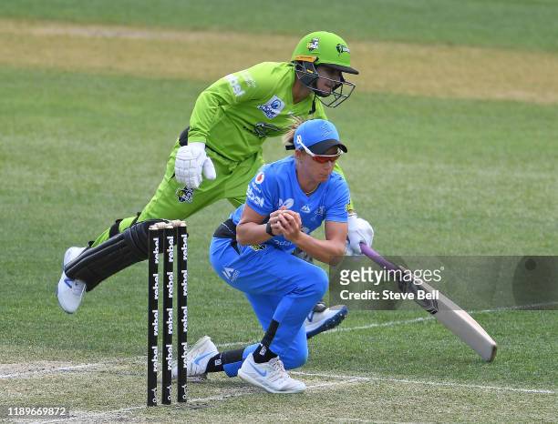 Lauren Winfield of the Strikers looks to runout Nida Dar of the Thunder during the Women's Big Bash League match between the Adelaide Strikers and...