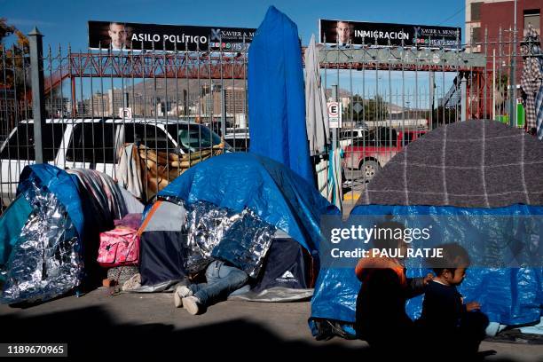 Children play at an encampment of Mexican asylum seekers by the Paso del Norte International Bridgein Ciudad Juarez, Mexico, on December 13, 2019. -...