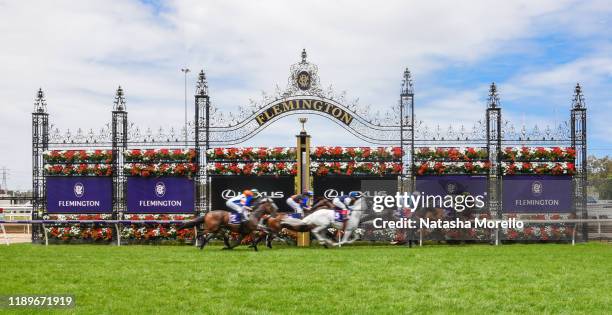 The field pass the post for the first time in the Christmas Carols Handicap at Flemington Racecourse on December 21, 2019 in Flemington, Australia.