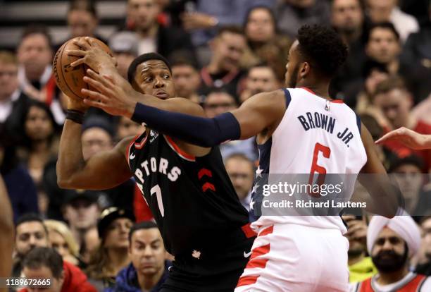 December 20 In second half action, Toronto Raptors guard Kyle Lowry looks for a pass around Washington Wizards guard Troy Brown Jr. The Toronto...