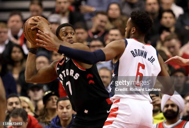 December 20 In second half action, Toronto Raptors guard Kyle Lowry looks for a pass around Washington Wizards guard Troy Brown Jr. The Toronto...