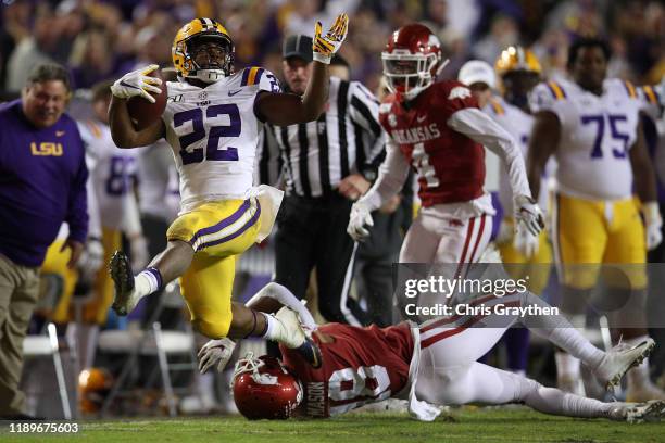 Clyde Edwards-Helaire of the LSU Tigers avoids a tackle by Jarques McClellion of the Arkansas Razorbacks to score a touchdown at Tiger Stadium on...
