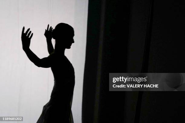 Dancer of the Monte-Carlo ballet warms-up in the backstage during the rehearsal of the ballet show "Coppel-i.A" a creation by French dancer and...