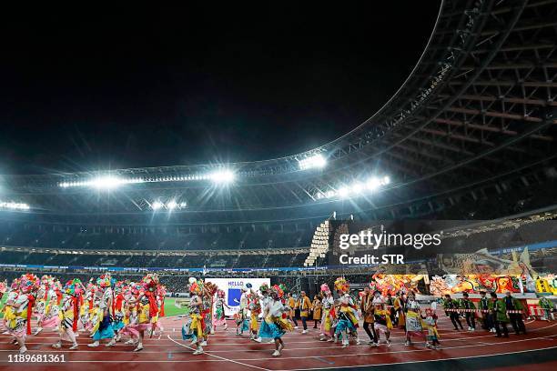 Performers participate in festival costumes of Tohoku region or Northeast Japan during the opening event for new National Stadium, venue for the...